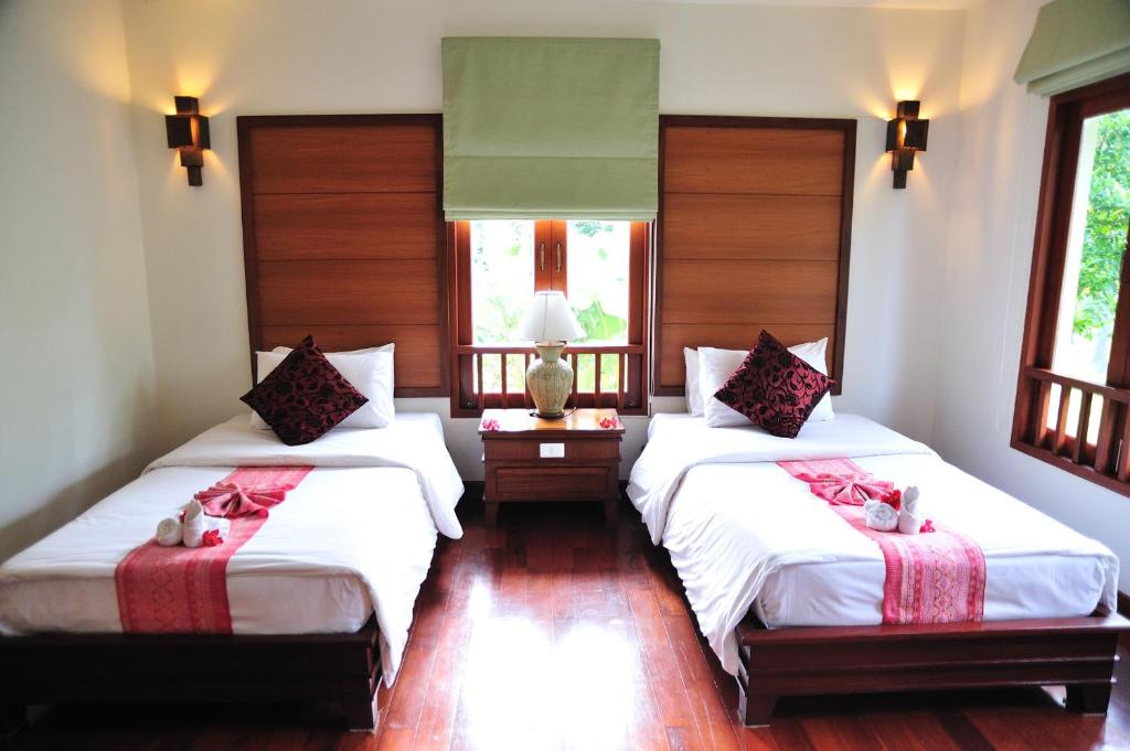 Postel nebo postele na pokoji v ubytování Teak Garden Resort, Chiang Rai