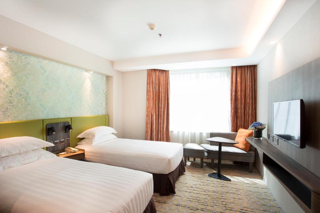 Katil atau katil-katil dalam bilik di Wharney Hotel