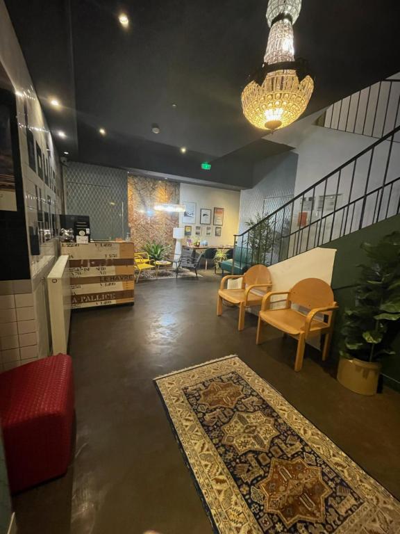 a lobby with chairs and a table and a rug at The Originals Boutique, Hôtel d&#39;Angleterre, Le Havre, centre, plage in Le Havre