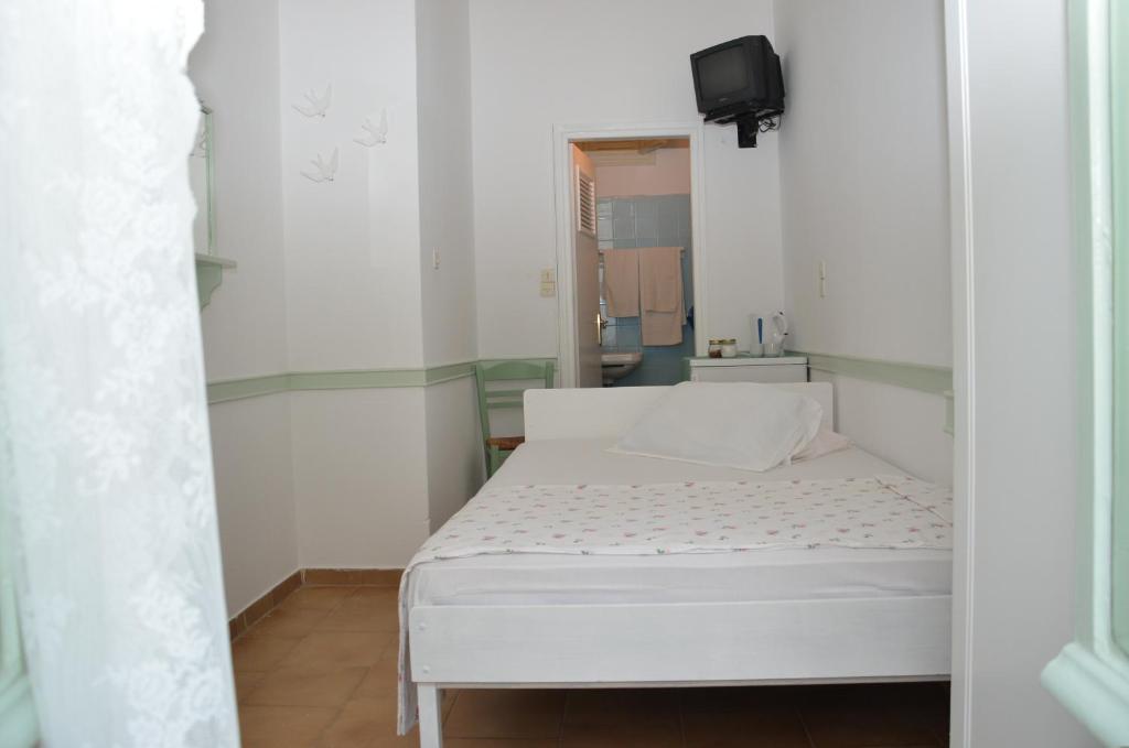 Postel nebo postele na pokoji v ubytování Aegli Rooms