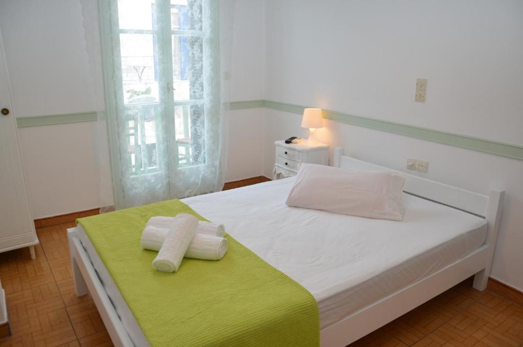 Postel nebo postele na pokoji v ubytování Aegli Rooms