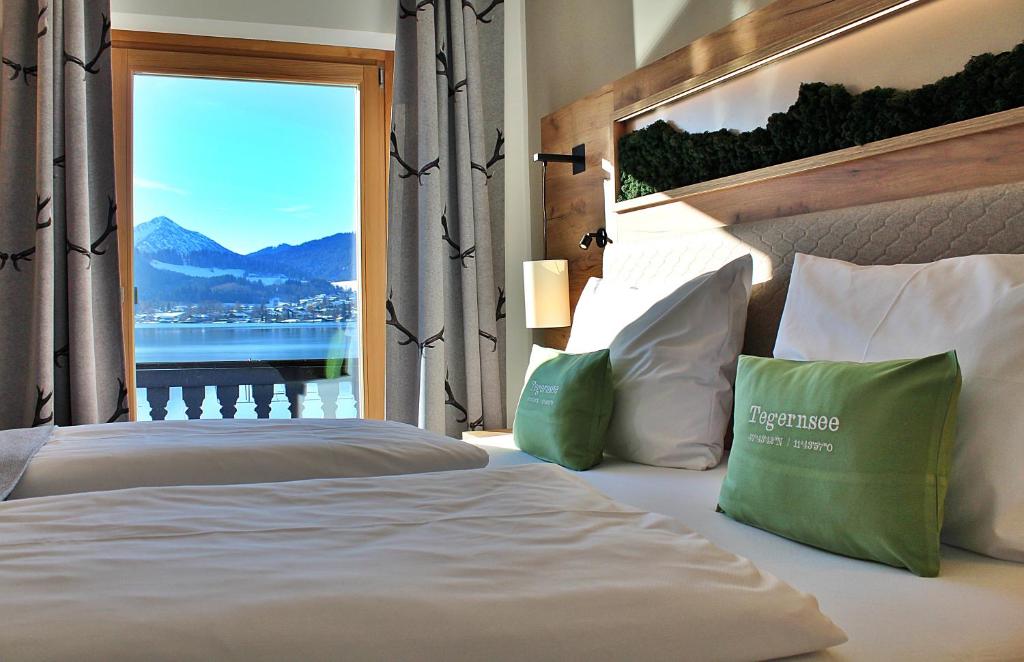 a bedroom with a bed with a view of the mountains at Seehotel zur Post in Tegernsee