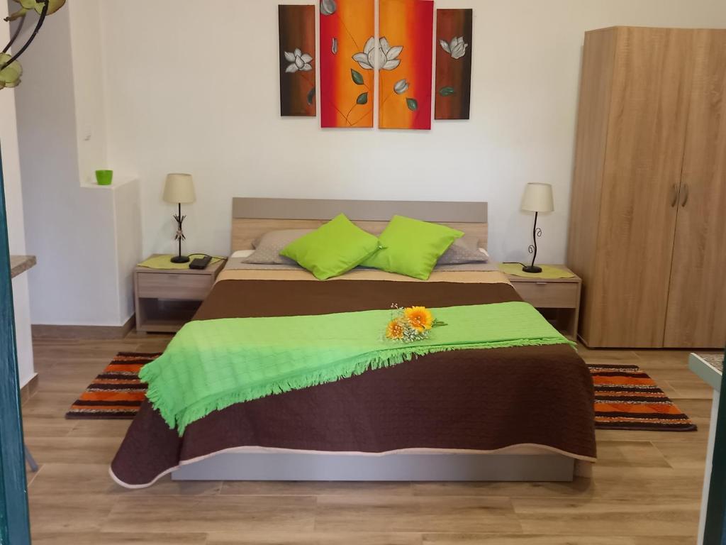 a bedroom with a bed with a flower on it at Tabua Village in Ribeira Brava