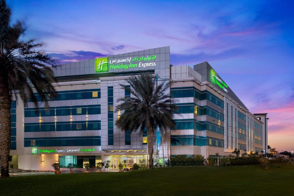 a large building with a large clock on the side of it at Holiday Inn Express Dubai Airport, an IHG Hotel in Dubai
