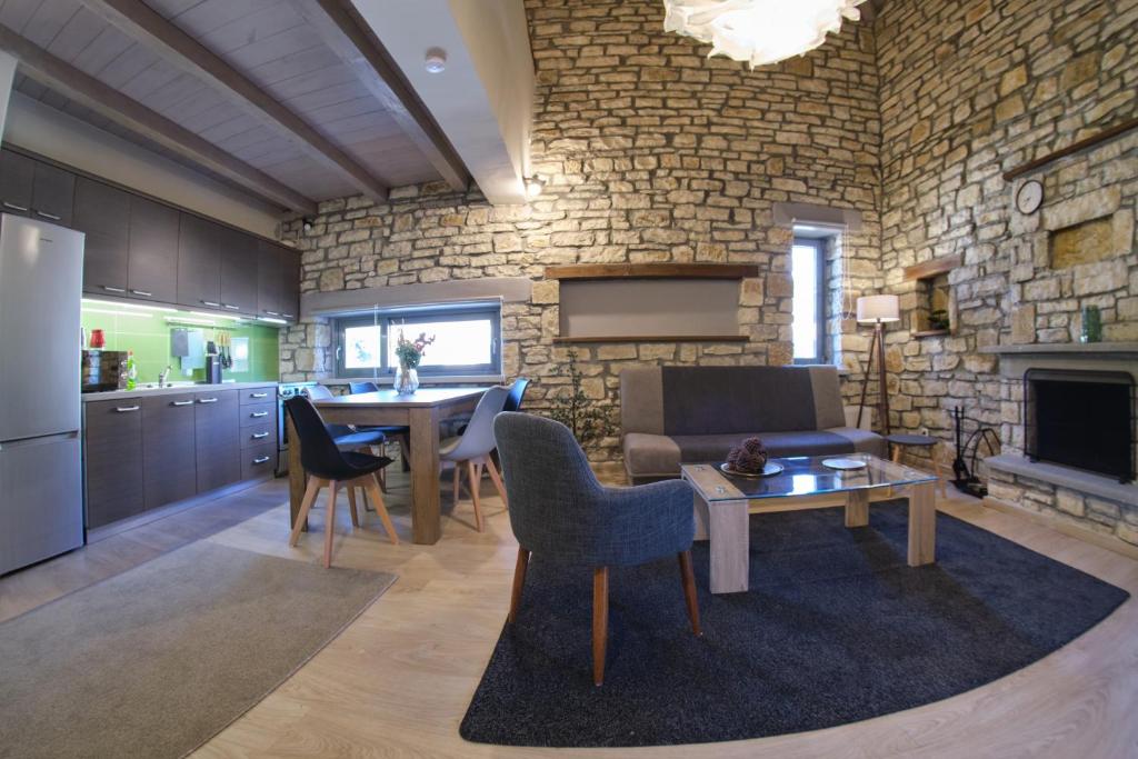 Kalpaki luxury maisonette 4 في Kalpákion: مطبخ وغرفة معيشة مع أريكة وطاولة