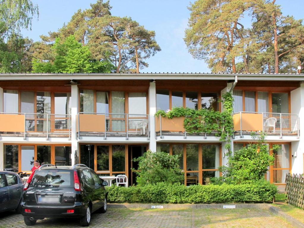 a building with cars parked in front of it at Holiday Home Strandvilla - LUB117 by Interhome in Lubmin