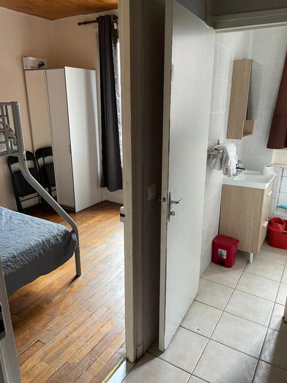 a room with a bedroom with a sink and a bed at RENT APPART - Colombes in Colombes