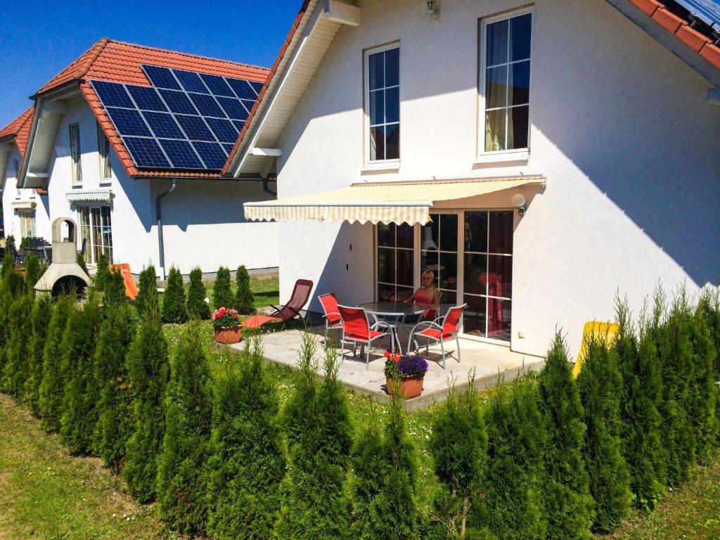a house with a solar roof with a table and chairs at Holiday Home Ferienpark Verchen-2 by Interhome in Verchen