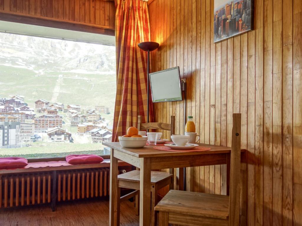 uma mesa e cadeira num quarto com uma janela em Apartment Les Pistes-3 by Interhome em Tignes