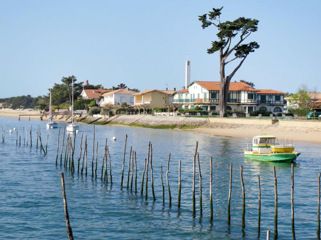 a small boat in the water next to a beach at Studio Las Delicias by Interhome in Cap-Ferret