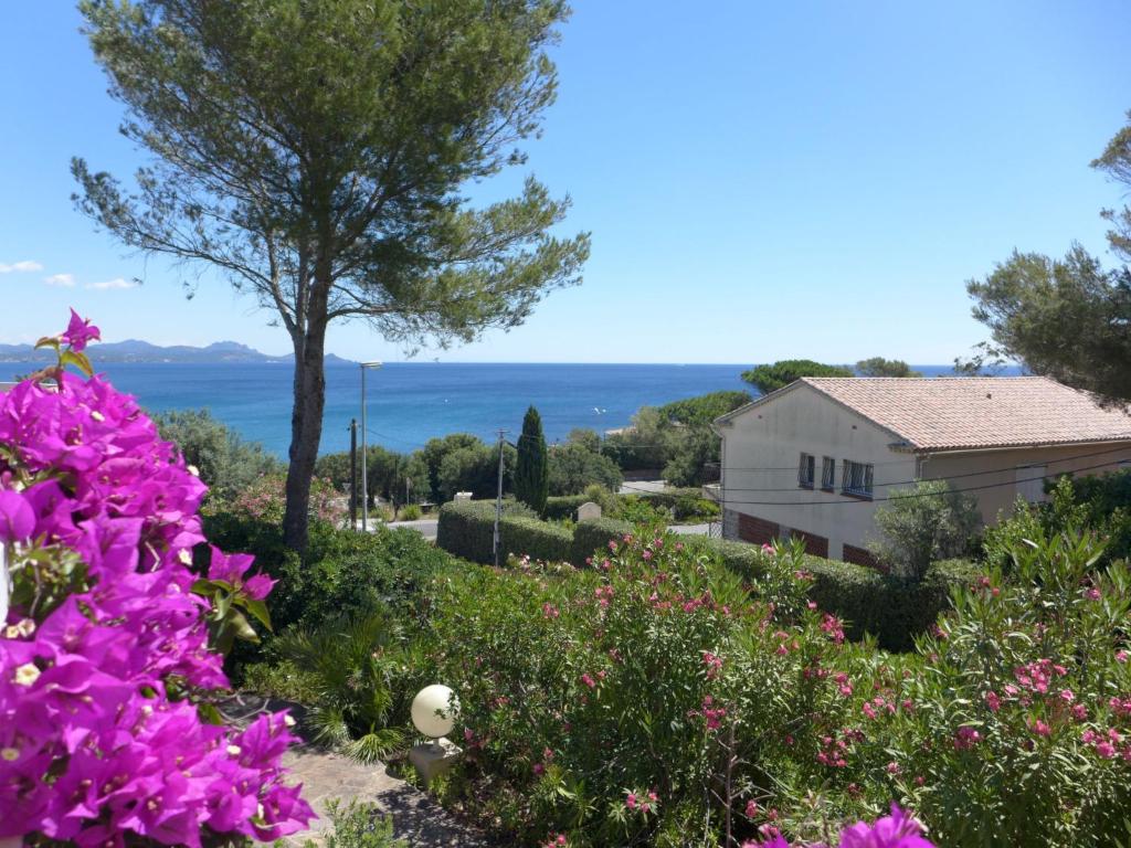a view from the garden of a house with flowers at Holiday Home Carpe Diem by Interhome in Les Issambres