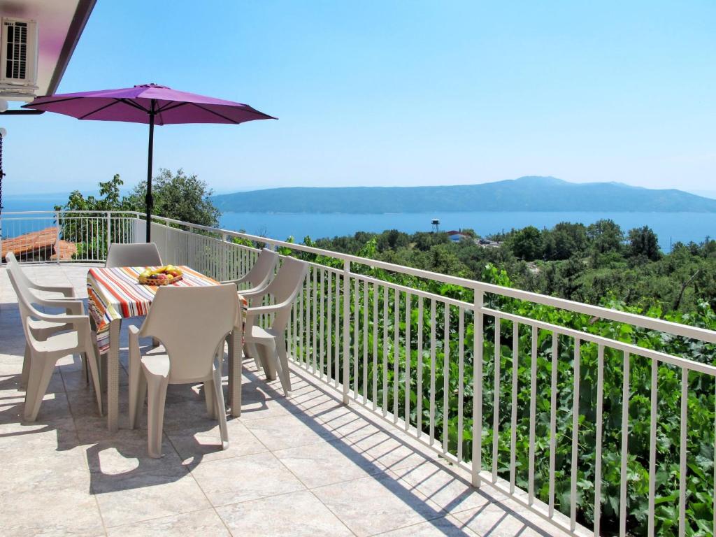a table and chairs on a balcony with a view of the water at Holiday Home Mirela by Interhome in Martina