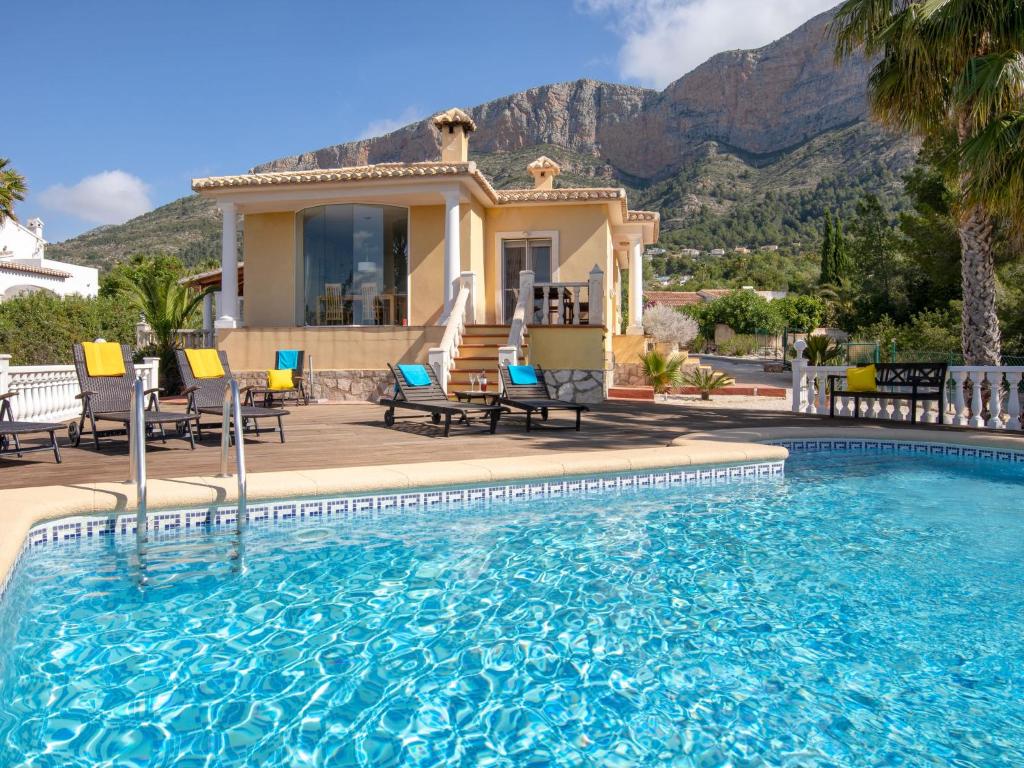 a house with a swimming pool in front of a house at Holiday Home Osa Menor by Interhome in Montgo