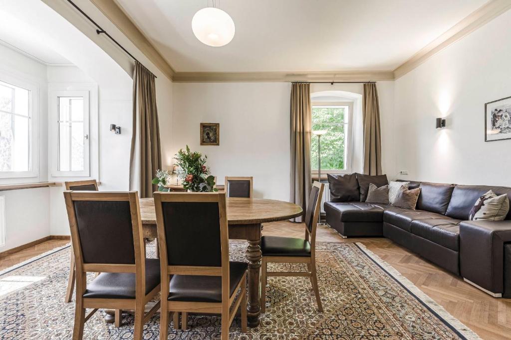 a living room with a table and a couch at Villa Martiner Apartments Alex in Ortisei