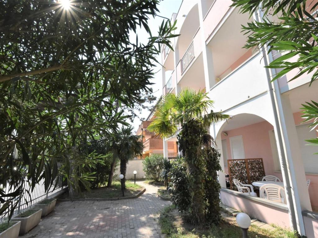 a walkway in front of a building with trees at Apartment Doria Uno by Interhome in Lido degli Estensi