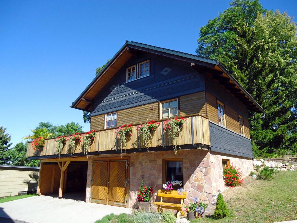 a house with flower boxes on the side of it at Chalet Weitsicht by Interhome in Lichtenhain