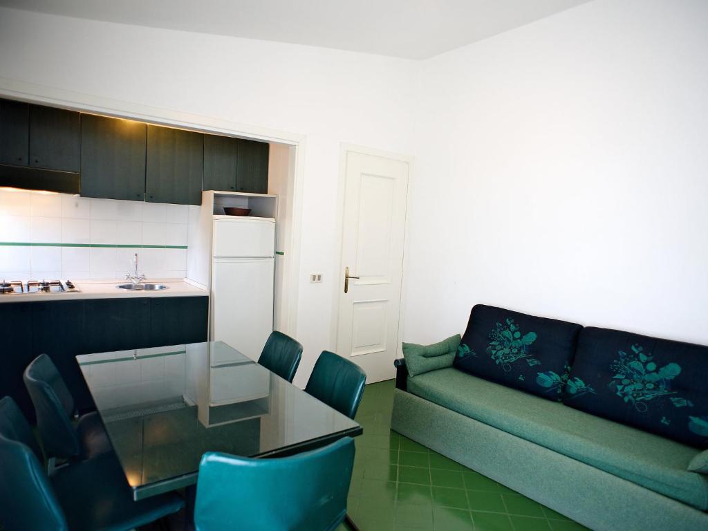 a living room with a couch and a table and a kitchen at Apartment Costa di Kair ed Din-6 by Interhome in Sperlonga