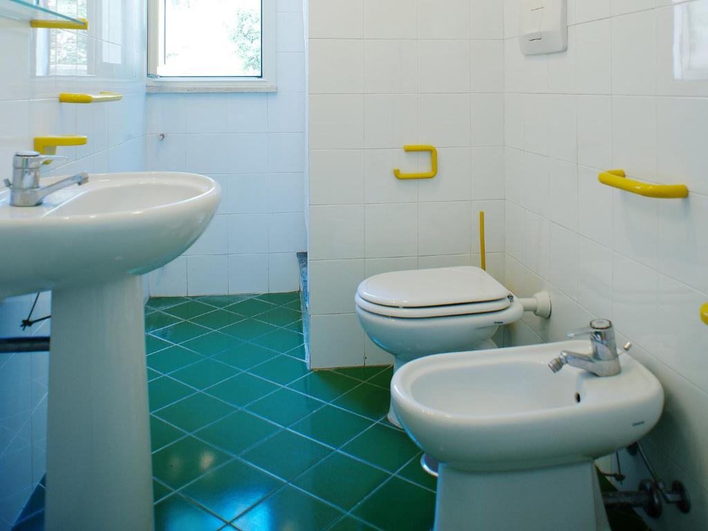 a bathroom with a white toilet and a sink at Apartment Costa di Kair ed Din-6 by Interhome in Sperlonga