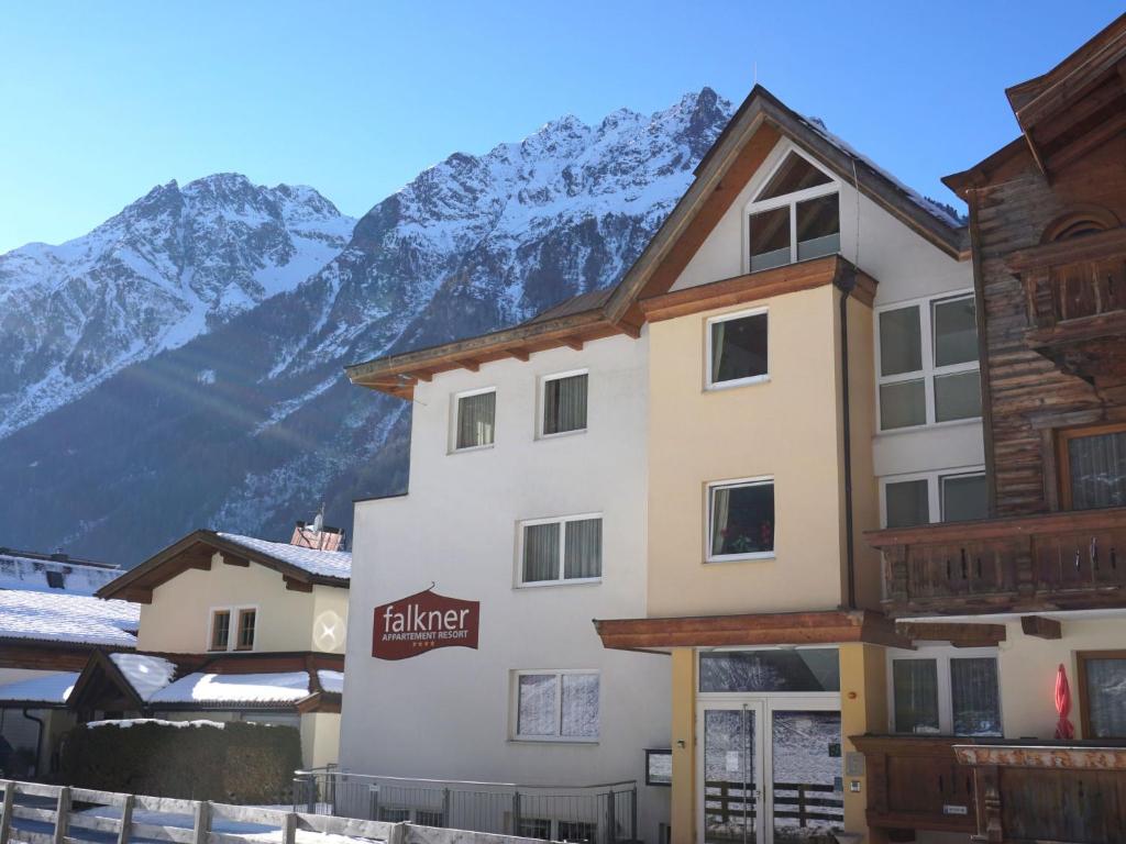 a hotel with mountains in the background at Apartment Falkner-1 by Interhome in Oberlängenfeld