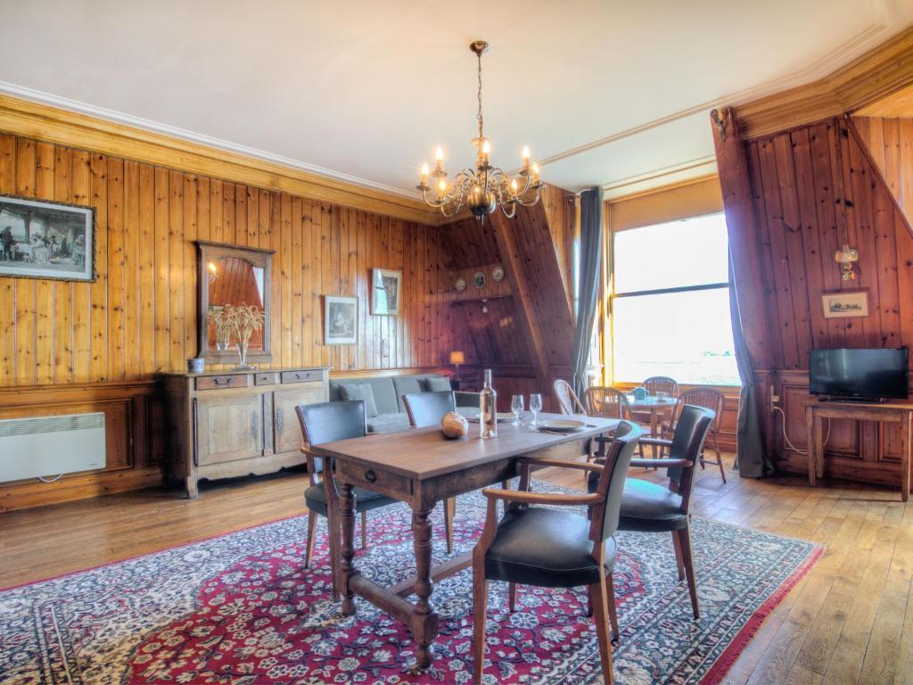 a dining room with a table and chairs at Studio La Garde by Interhome in Dinard