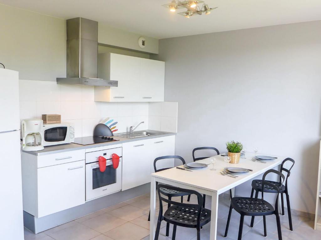 a kitchen with a table and chairs in a room at Apartment Amigorena-1 by Interhome in Bidart