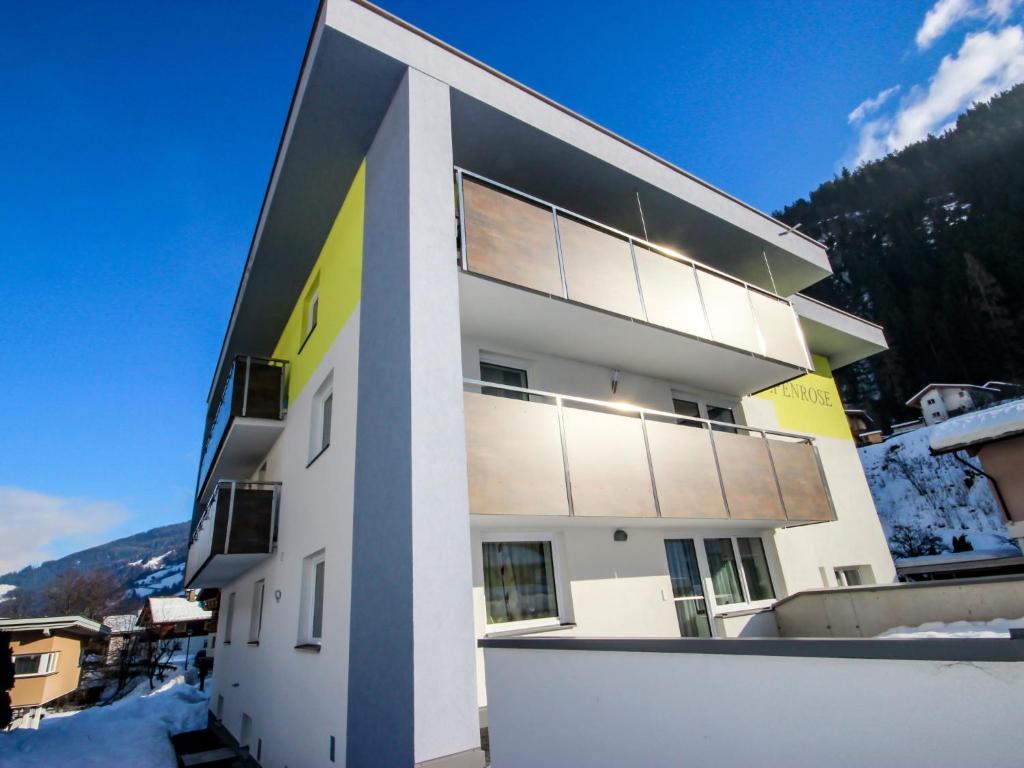 a white building with snow on the ground at Apartment Alpenrose-2 by Interhome in See
