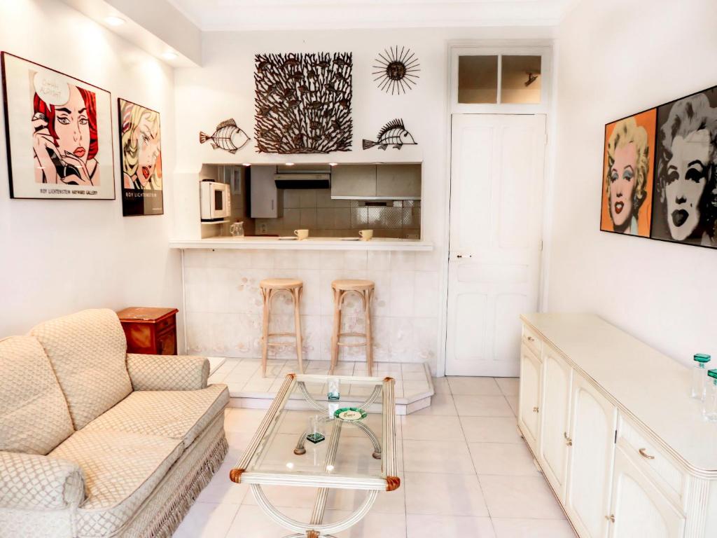 a living room with a couch and a table at Apartment Le Concordia by Interhome in Nice