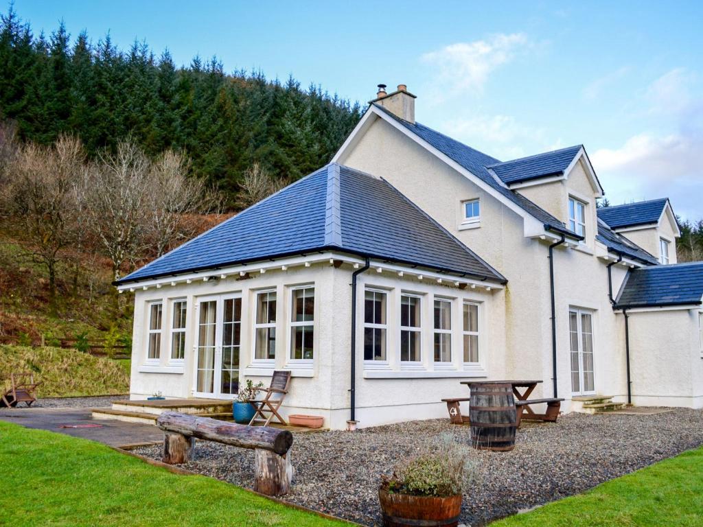 a large white house with a solar roof at Holiday Home Feochan Bheag by Interhome in Kilmore