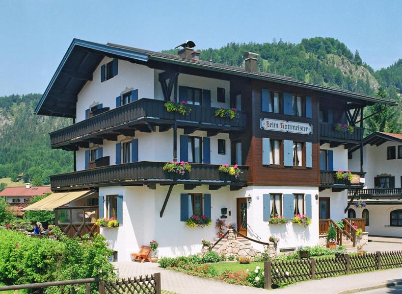 a large white building with flowers on the windows at Beim Rottmeister in Reit im Winkl