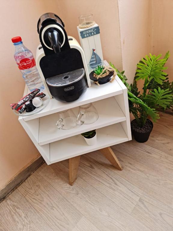 a white cabinet with a tea kettle on top of it at FamilyConfort Saidia in Saïdia