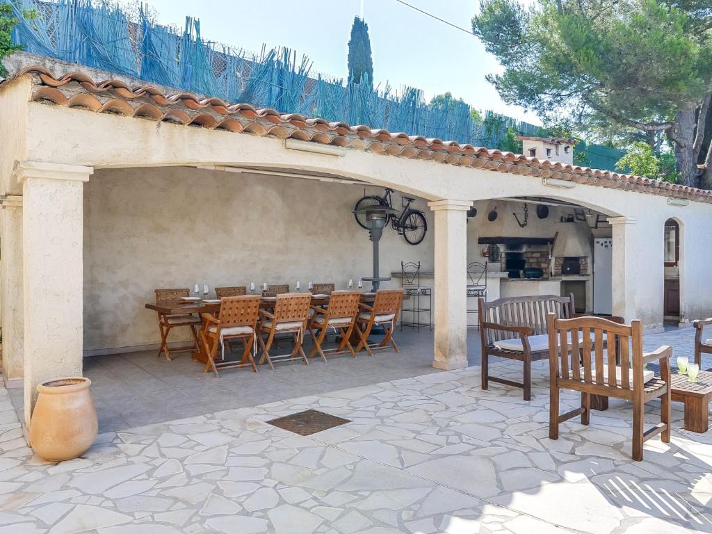 a patio with a table and chairs on a patio at Holiday Home Nicoleine by Interhome in Cagnes-sur-Mer