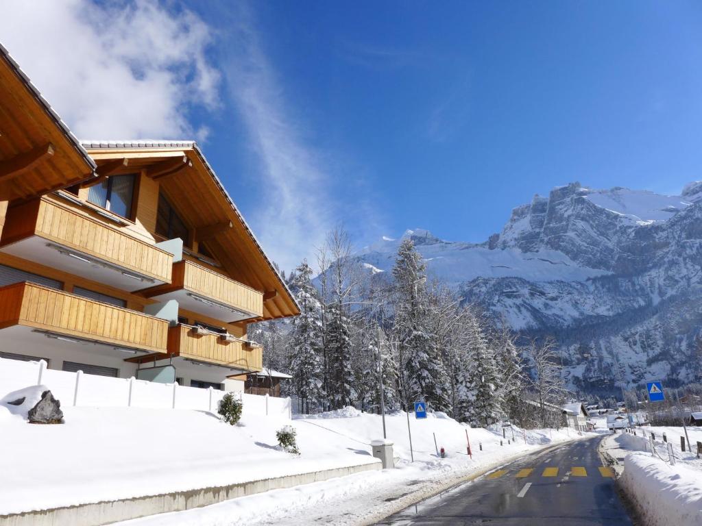 a snow covered road next to a building at Apartment Verena by Interhome in Kandersteg