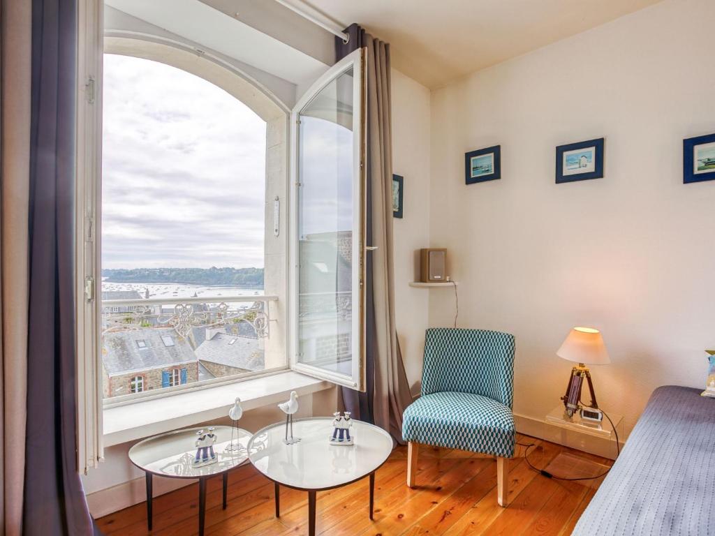 a bedroom with a bed and a large window at Apartment Ker Louis 2 by Interhome in Dinard