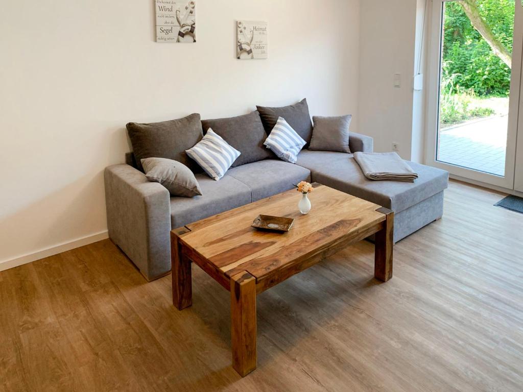 a living room with a couch and a wooden coffee table at Apartment Spiekeroog by Interhome in Westerholt