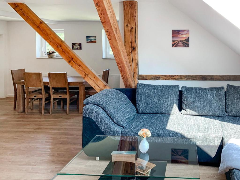 a living room with a blue couch and a table at Apartment Borkum by Interhome in Westerholt
