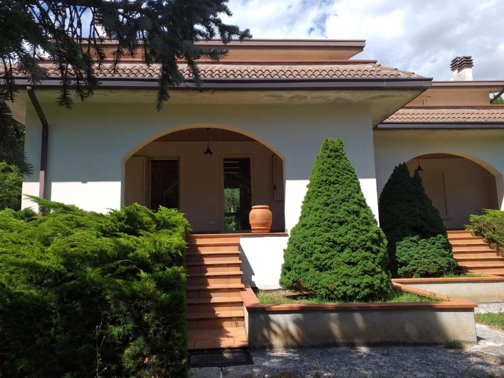 a house with trees in the front yard at Villa Angela Santa Maria del Molise in Santa Maria del Molise