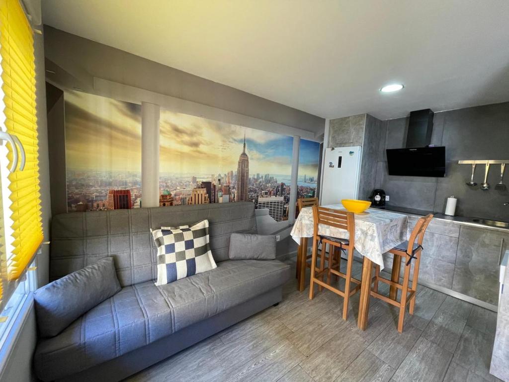 a living room with a gray couch and a table at Apartment near Arts & Science in Valencia