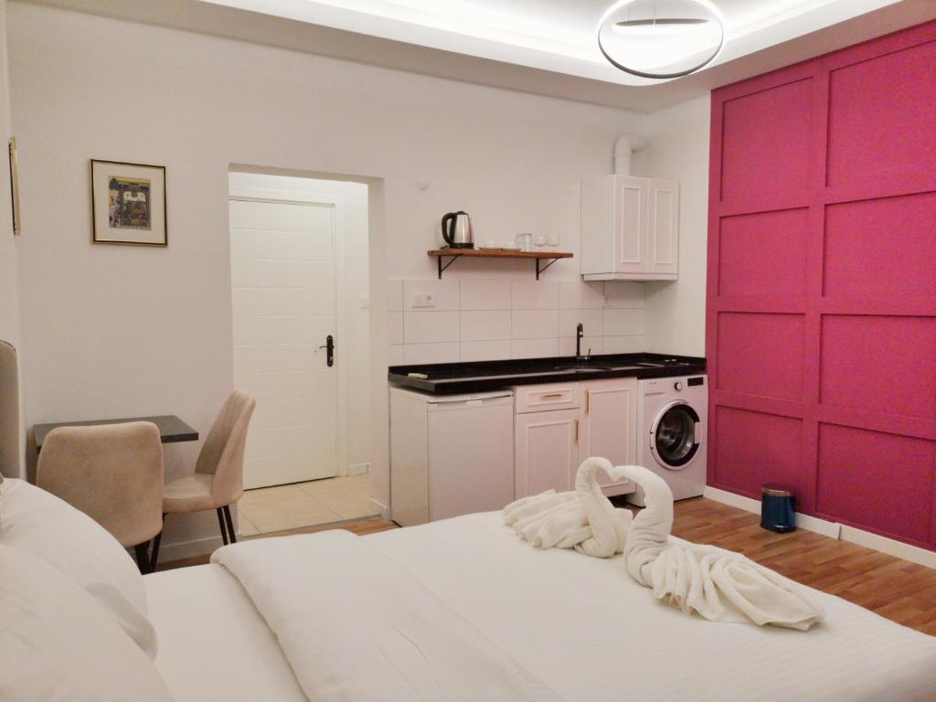 a room with a red door with a towel on a bed at St Moscow Suites Taksim in Istanbul
