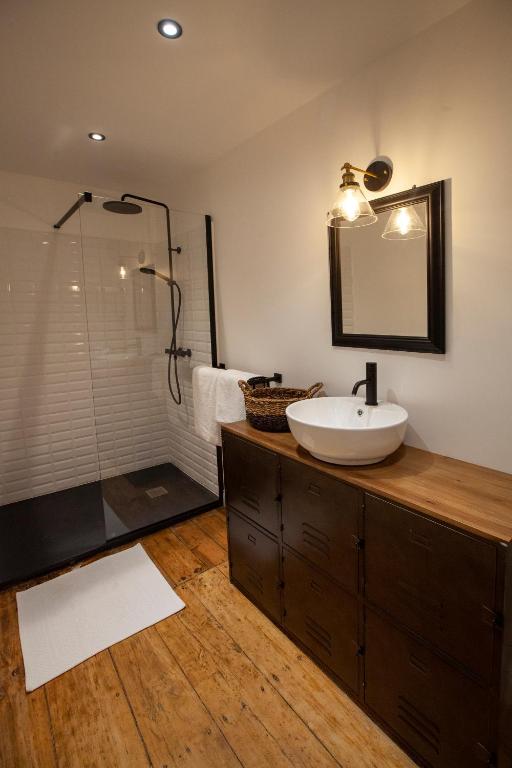 a bathroom with a sink and a shower at NAMASTE COTTAGE in Issigeac