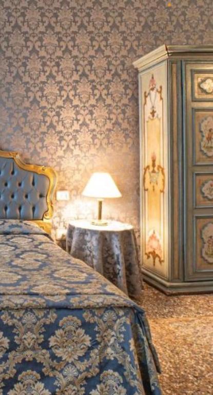 Łóżko lub łóżka w pokoju w obiekcie palazzo suite ducale