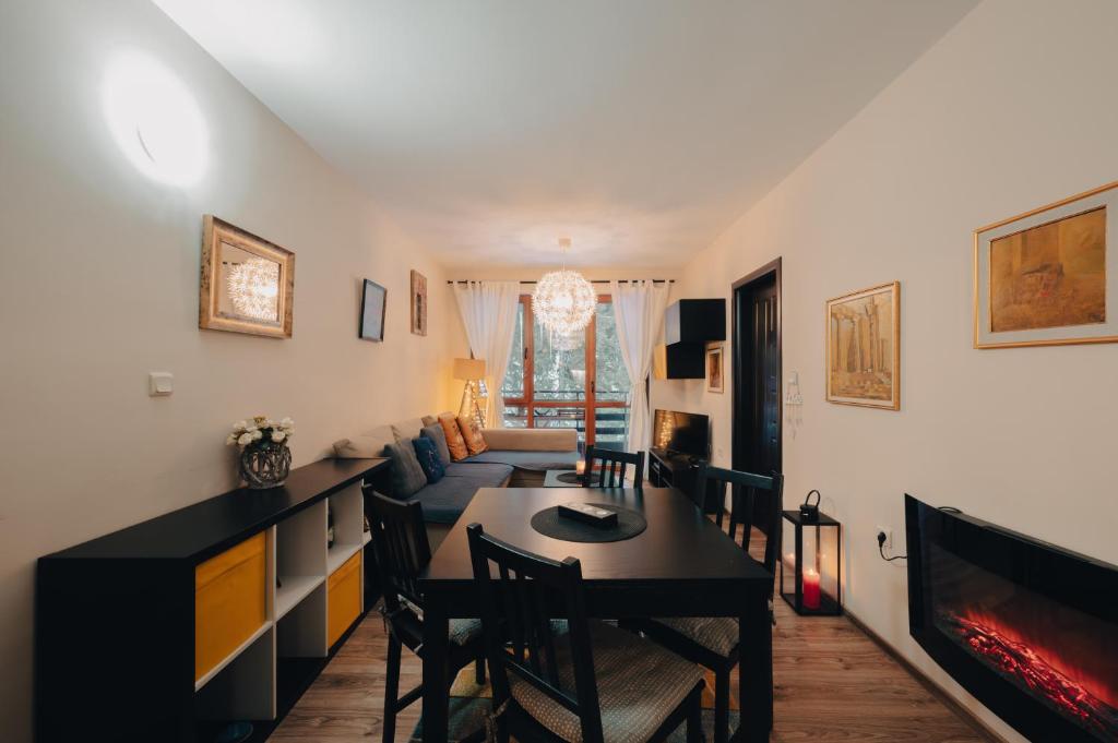 a living room with a couch and a table at Max Holiday Apartment in Pamporovo