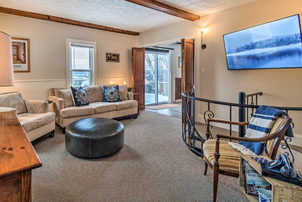 a living room with a couch and a table at Spectacular Views with Deck, Fire Pit, and Game Room! in Keuka Park