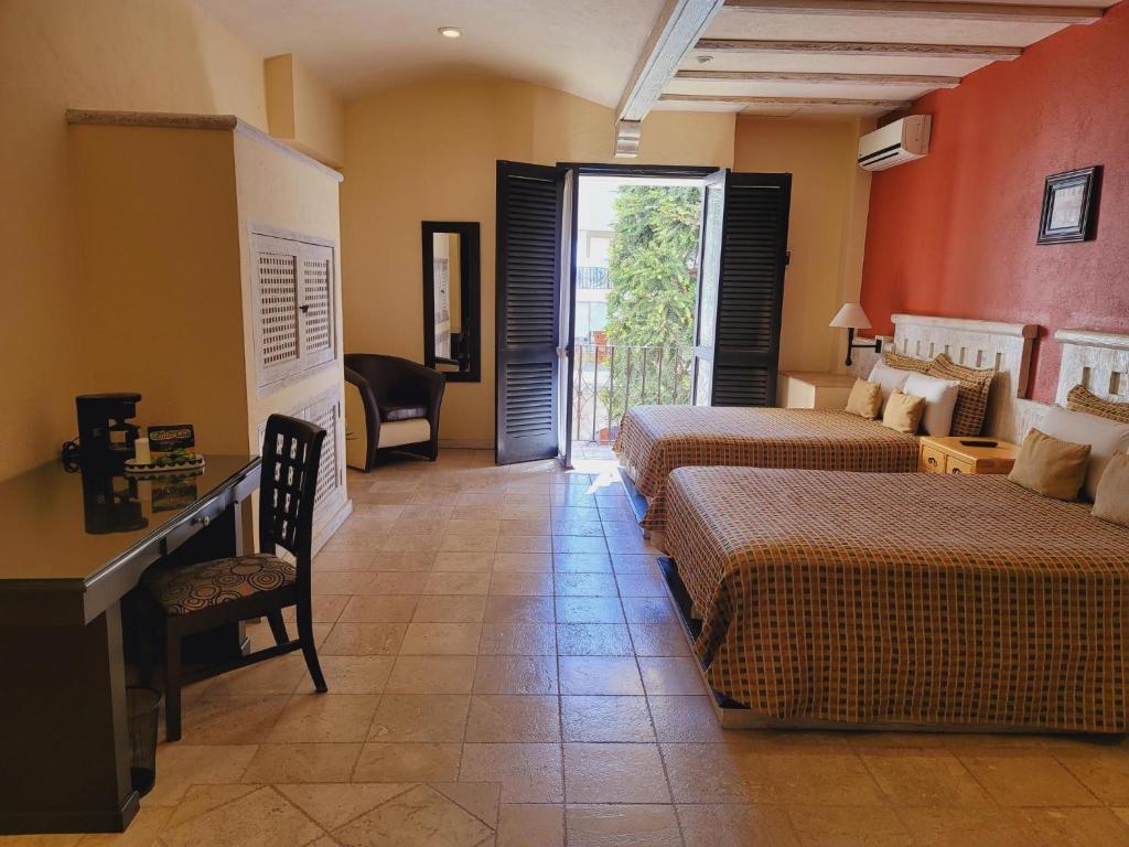 Postel nebo postele na pokoji v ubytování Hotel Quinta Las Alondras