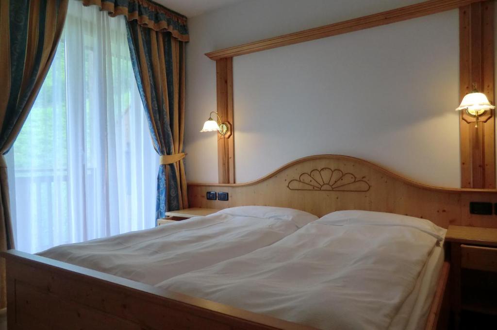 Postel nebo postele na pokoji v ubytování Garnì Costa Verde