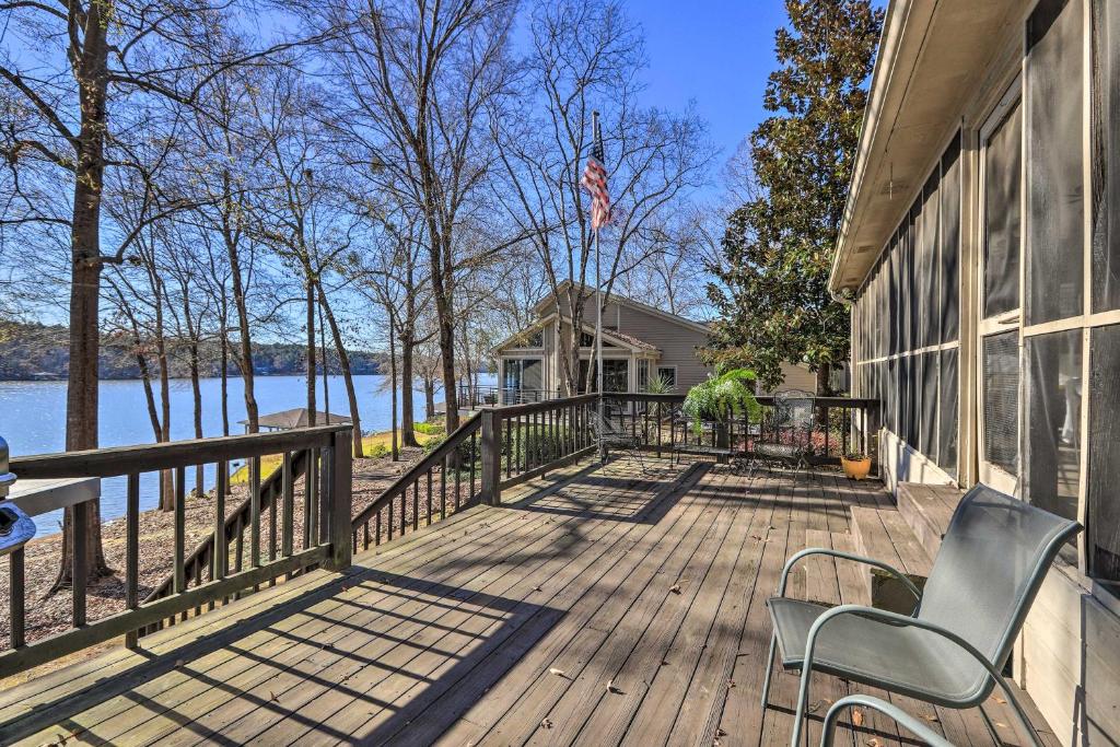 een huis met een terras met stoelen erop bij Pet-Friendly Lake Sinclair Home with Boat Dock! in Eatonton