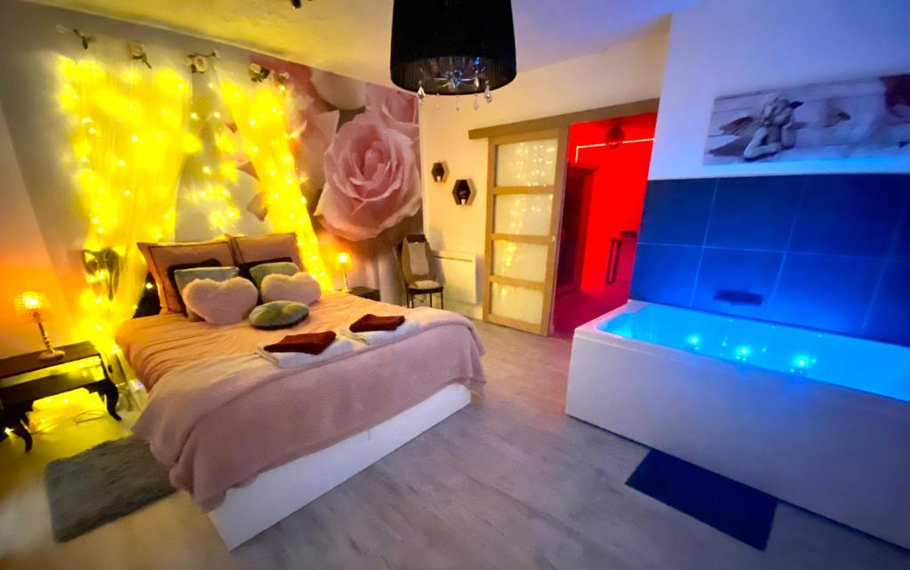 a bedroom with a large bed with lights on it at COSY & SPA Appartement Luxe JACUZZI SAUNA Suite Cristal in Avignon