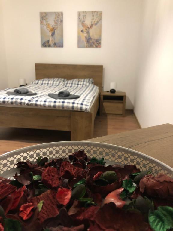 a room with two beds and a plate of food on a table at Mormota Vendégház in Mezőkövesd