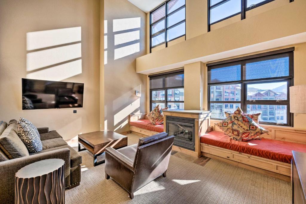 a large living room with a fireplace and windows at Spacious Ski In and Ski Out Condo with Fireplace and View in Park City