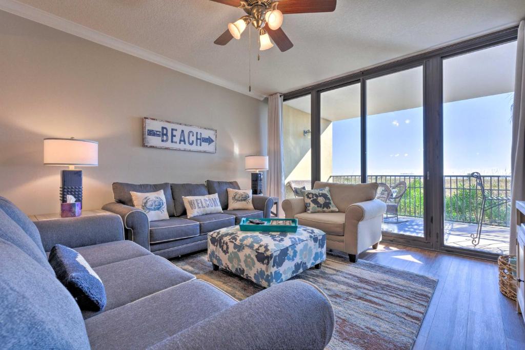a living room with a couch and a table at Sunny 1st-Floor Condo with Ocean-View Balcony! in Dauphin Island