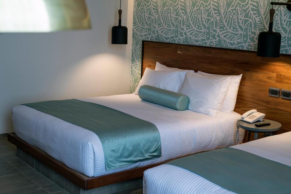 Postel nebo postele na pokoji v ubytování Hotel Y Parque Acuático La Caldera